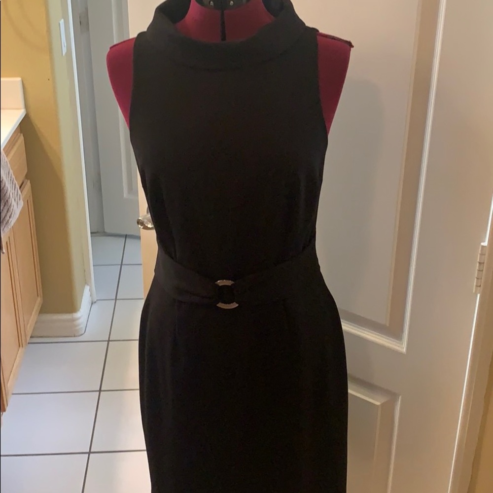 Expertly tailored black sheath.